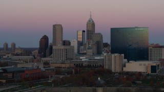 DX0001_002944 - 5.7K aerial stock footage of ascending near city's skyline and hotel at sunset, Downtown Indianapolis, Indiana