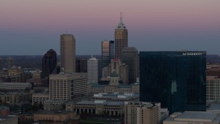 DX0001_002945 - 5.7K aerial stock footage of passing by city's skyline and hotel at sunset, Downtown Indianapolis, Indiana