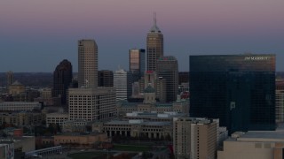 DX0001_002950 - 5.7K aerial stock footage slowly flyby the city's skyline and a hotel at sunset in Downtown Indianapolis, Indiana