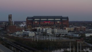 DX0001_002952 - 5.7K aerial stock footage slowly flyby a football stadium at sunset, Downtown Indianapolis, Indiana