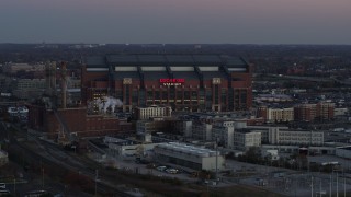 DX0001_002953 - 5.7K aerial stock footage slowly flying away from a football stadium at sunset, Downtown Indianapolis, Indiana