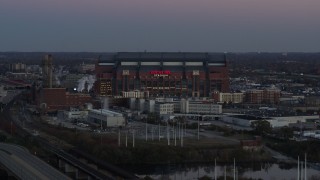 DX0001_002955 - 5.7K aerial stock footage slow approach to a football stadium at sunset, Downtown Indianapolis, Indiana