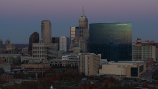 DX0001_002956 - 5.7K aerial stock footage slow pass by hotel at twilight, Downtown Indianapolis, Indiana skyline in background