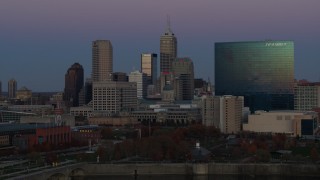 DX0001_002958 - 5.7K stock footage aerial video of slowly flying by hotel and city skyline at twilight in Downtown Indianapolis, Indiana