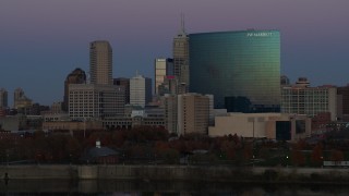 DX0001_002959 - 5.7K aerial stock footage of slowly descending by hotel and city skyline at twilight in Downtown Indianapolis, Indiana