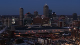 DX0001_002967 - 5.7K aerial stock footage the city skyline behind convention center at twilight, Downtown Indianapolis, Indiana