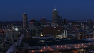 DX0001_002975 - 5.7K aerial stock footage flyby smoke stacks and skyscrapers of the city skyline at twilight, Downtown Indianapolis, Indiana