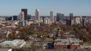 DX0001_002982 - 5.7K stock footage aerial video of slowly flying away from and by the city's skyline, seen from apartment buildings, Downtown Louisville, Kentucky