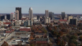 DX0001_002984 - 5.7K stock footage aerial video flying by the city's skyline, seen near churches in Downtown Louisville, Kentucky
