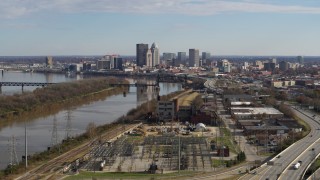 DX0001_002998 - 5.7K stock footage aerial video passing by the river with view of the city's skyline in Downtown Louisville, Kentucky