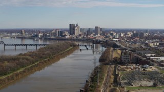 DX0001_002999 - 5.7K stock footage aerial video of the city's skyline seen while flying by the river in Downtown Louisville, Kentucky