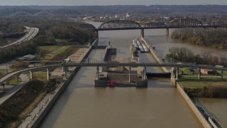 DX0001_003012 - 5.7K stock footage aerial video flying by locks and a dam on the Ohio River in Louisville, Kentucky