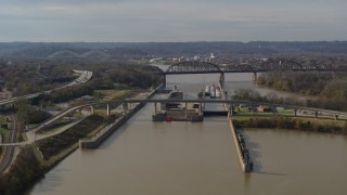 DX0001_003013 - 5.7K stock footage aerial video reverse view of locks and a dam on the Ohio River in Louisville, Kentucky