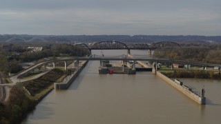DX0001_003015 - 5.7K stock footage aerial video approach locks and a dam on the Ohio River before ascent in Louisville, Kentucky