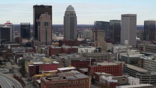 DX0001_003022 - 5.7K stock footage aerial video ascend and approach the city skyline from freeway offramp in Downtown Louisville, Kentucky