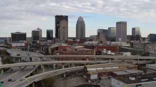 DX0001_003026 - 5.7K aerial stock footage ascend over freeway to approach the city skyline in Downtown Louisville, Kentucky