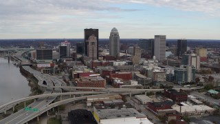 DX0001_003028 - 5.7K stock footage aerial video fly away from the city's skyline beside a freeway in Downtown Louisville, Kentucky
