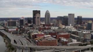 DX0001_003031 - 5.7K stock footage aerial video ascend and fly away from freeway and city skyline in Downtown Louisville, Kentucky