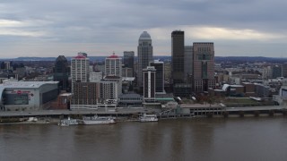 DX0001_003042 - 5.7K aerial stock footage of flying by the city skyline beside the river in Downtown Louisville, Kentucky