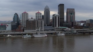 DX0001_003048 - 5.7K stock footage aerial video passing the city skyline beside the Ohio River during descent in Downtown Louisville, Kentucky