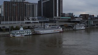 DX0001_003061 - 5.7K stock footage aerial video orbit historic riverboat docked by Downtown Louisville, Kentucky