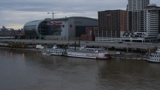 DX0001_003062 - 5.7K aerial stock footage reverse view of historic riverboat docked by Downtown Louisville, Kentucky