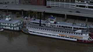 DX0001_003064 - 5.7K stock footage aerial video close-up view of the historic riverboat docked by Downtown Louisville, Kentucky