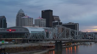 DX0001_003079 - 5.7K aerial stock footage view of arena and city skyline at sunset from the bridge, Downtown Louisville, Kentucky