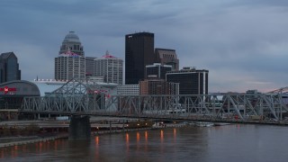 DX0001_003080 - 5.7K aerial stock footage view of city skyline at sunset while passing the bridge, Downtown Louisville, Kentucky