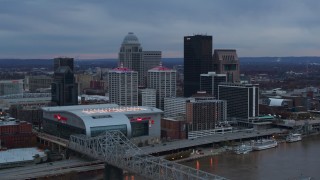 DX0001_003082 - 5.7K stock footage aerial video fly toward arena and city skyline at sunset from the bridge, Downtown Louisville, Kentucky