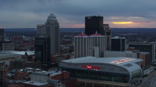 DX0001_003087 - 5.7K aerial stock footage fly away from the arena and city skyline at sunset, Downtown Louisville, Kentucky