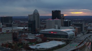 DX0001_003088 - 5.7K aerial stock footage flyby the arena and city skyline at sunset, Downtown Louisville, Kentucky