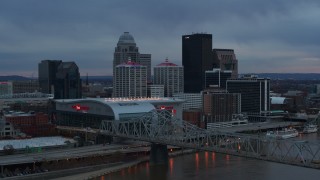 DX0001_003089 - 5.7K stock footage aerial video flyby the arena, city skyline, and bridge over the river at sunset, Downtown Louisville, Kentucky