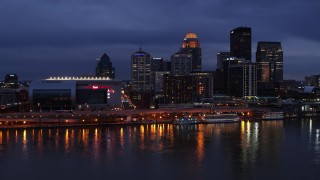 DX0001_003103 - 5.7K aerial stock footage approach the skyline and arena lit up at twilight from the Ohio River, Downtown Louisville, Kentucky