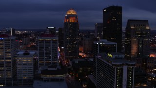 DX0001_003106 - 5.7K aerial stock footage of a tall skyscraper lit up at twilight, Downtown Louisville, Kentucky