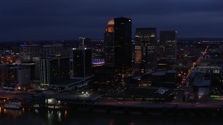 DX0001_003108 - 5.7K aerial stock footage reverse view of the city's skyline at twilight, reveal Ohio River, Downtown Louisville, Kentucky
