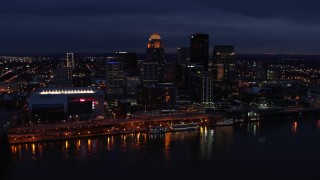 DX0001_003111 - 5.7K stock footage aerial video slowly fly away from and by the city's skyline at twilight, seen from Ohio River, Downtown Louisville, Kentucky