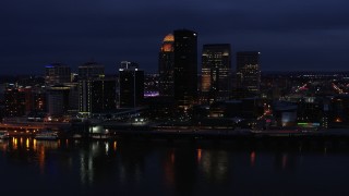 DX0001_003113 - 5.7K stock footage aerial video approach the city's skyline at twilight from the Ohio River, Downtown Louisville, Kentucky
