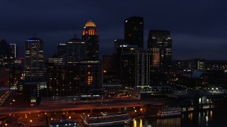 DX0001_003115 - 5.7K stock footage aerial video reverse view of hotel and the city skyline at twilight, reveal river, Downtown Louisville, Kentucky
