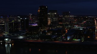 DX0001_003121 - 5.7K stock footage aerial video slowly flying past the city skyline at twilight, seen from the river, Downtown Louisville, Kentucky