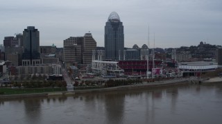 DX0001_003126 - 5.7K aerial stock footage a view of the baseball stadium and skyscraper during descend toward river, Downtown Cincinnati, Ohio