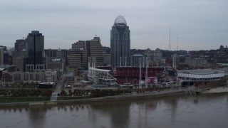 DX0001_003127 - 5.7K aerial stock footage a view of the baseball stadium and skyscraper during ascent over river, Downtown Cincinnati, Ohio