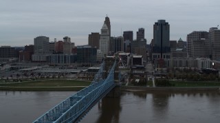 DX0001_003139 - 5.7K aerial stock footage ascend by bridge while focused on the city skyline, Downtown Cincinnati, Ohio