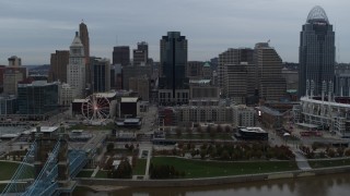 DX0001_003148 - 5.7K aerial stock footage ascend and fly away from city skyline, reveal the river, Downtown Cincinnati, Ohio