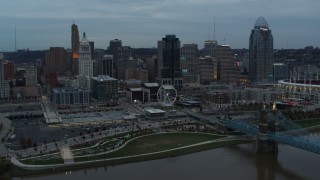 DX0001_003153 - 5.7K aerial stock footage of the city skyline seen from the Roebling Bridge over the river at sunset, Downtown Cincinnati, Ohio