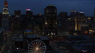 DX0001_003182 - 5.7K aerial stock footage of Scripps Center skyscraper at twilight, Downtown Cincinnati, Ohio