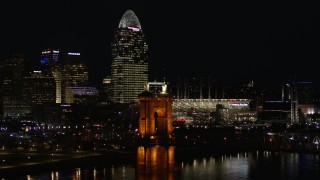 DX0001_003199 - 5.7K stock footage aerial video orbit Roebling Bridge at night with city skyline in background, Downtown Cincinnati, Ohio