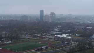 DX0001_003207 - 5.7K aerial stock footage reverse view of the city skyline seen from residential neighborhoods, Downtown Lexington, Kentucky