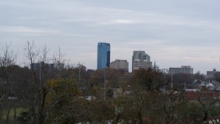 DX0001_003210 - 5.7K aerial stock footage ascend from trees to reveal city's skyline, Downtown Lexington, Kentucky