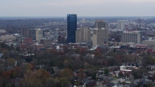DX0001_003215 - 5.7K aerial stock footage flyby and approach the city's skyline from tree-lined neighborhoods, Downtown Lexington, Kentucky